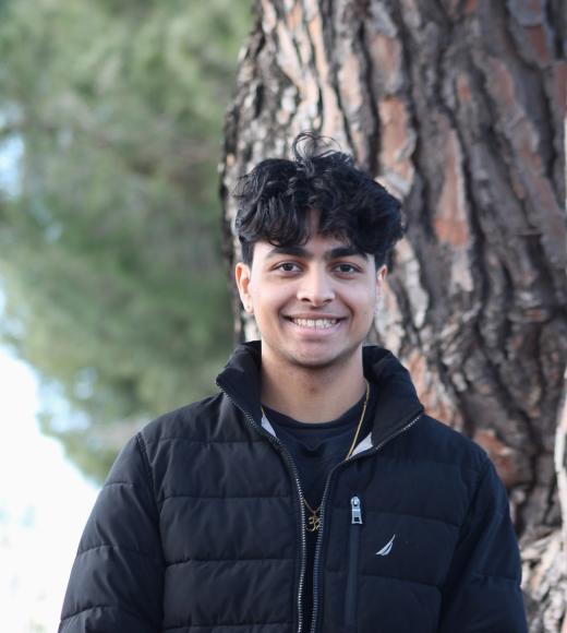 Aryan's portrait, standing in front of a tree