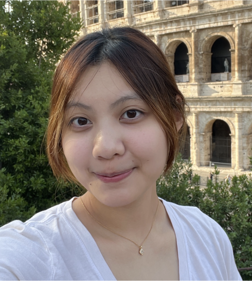 Abby sitting in front of a historic building