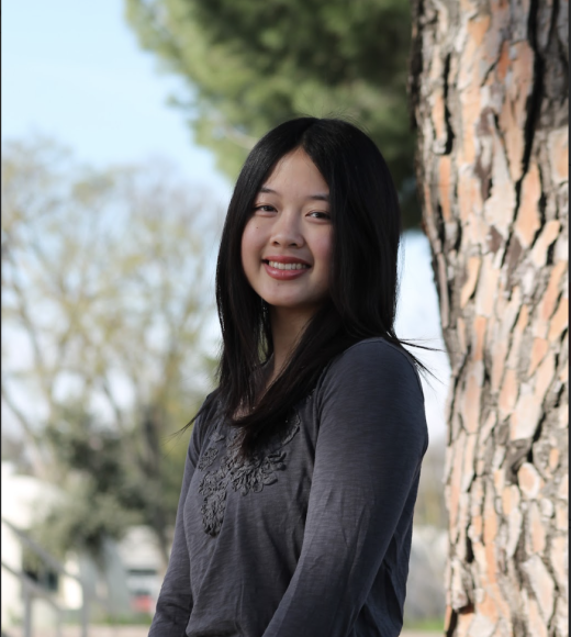 Girl standing in front of a tree