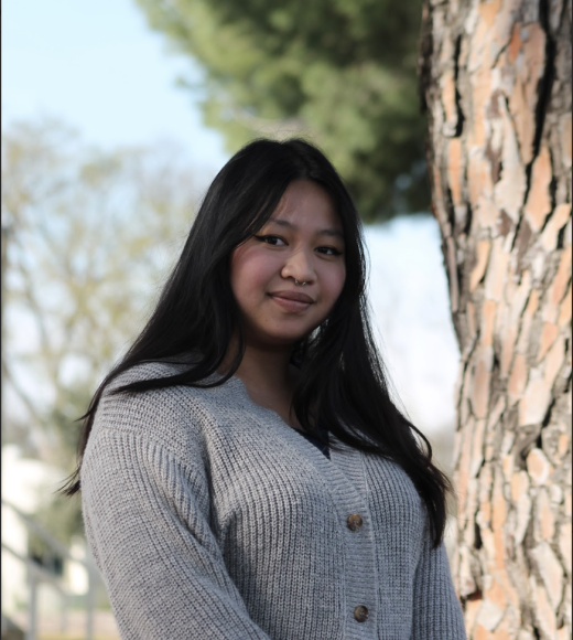 Girl standing in front of a tree